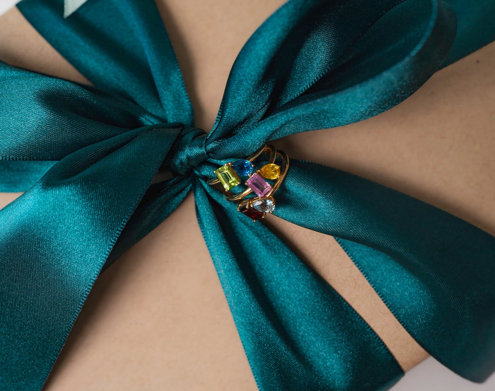 Custom gemstones ring on a emerald green bow