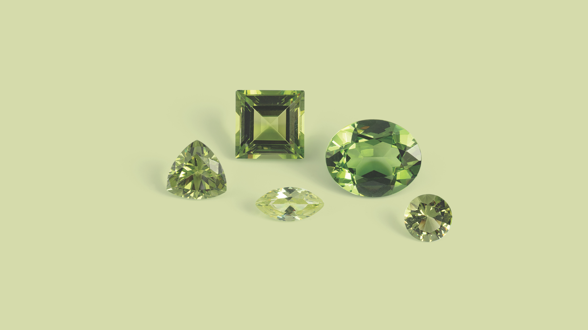 Green Peridot Gemstones on pale green background